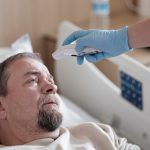 Person resting in bed while experiencing a fever